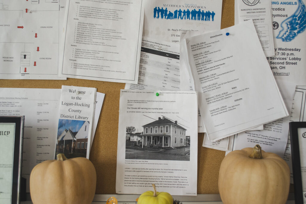 Bulletin board with pumpkins in front of it