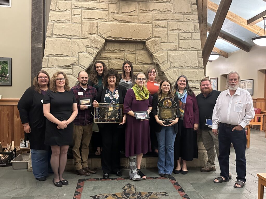 2023 Vinton County Award Winners. Pictured in front of the Lake Hope Lodge fireplace: Board Member Patricia Robinette, Board Member Tonya Bowden, Vinton County Behavioral Health Advocacy Award Winner Jeffrey Woodrum, Vinton County Behavioral Health Advocacy Award Winner Melanie Carte, Rita Gillick Award Winner Melissa Robson, Vinton County Behavioral Health Advocacy Award Winner Tia Elliot, Vinton County Behavioral Health Advocacy Award Winner Jodie Lucas, Vinton County Behavioral Health Advocacy Award Winner Nicole Hire, Taffy Marks Award Winner Lily Niple-Jenkins, Vinton County Behavioral Health Advocacy Award Winner Nancy Baur, Vinton County Behavioral Health Advocacy Award Winner Seth Fannin, and Board Member Robert Orth.
