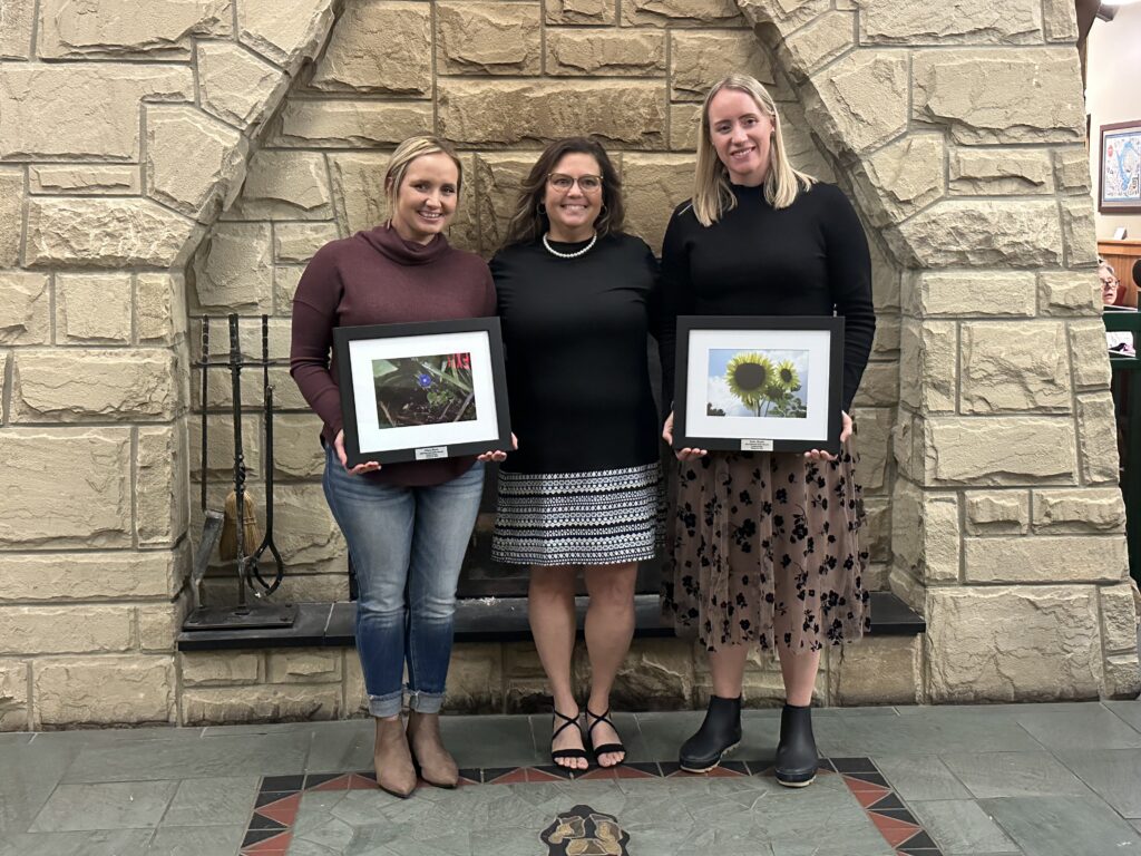 2023 Hocking County 317 Board Award Winners. Pictured in front of the Lake Hope Lodge fireplace: Award Winner Allison Blazer, Board Member Jacqueline Stobbs, and Award Winner Kathy Shepler.