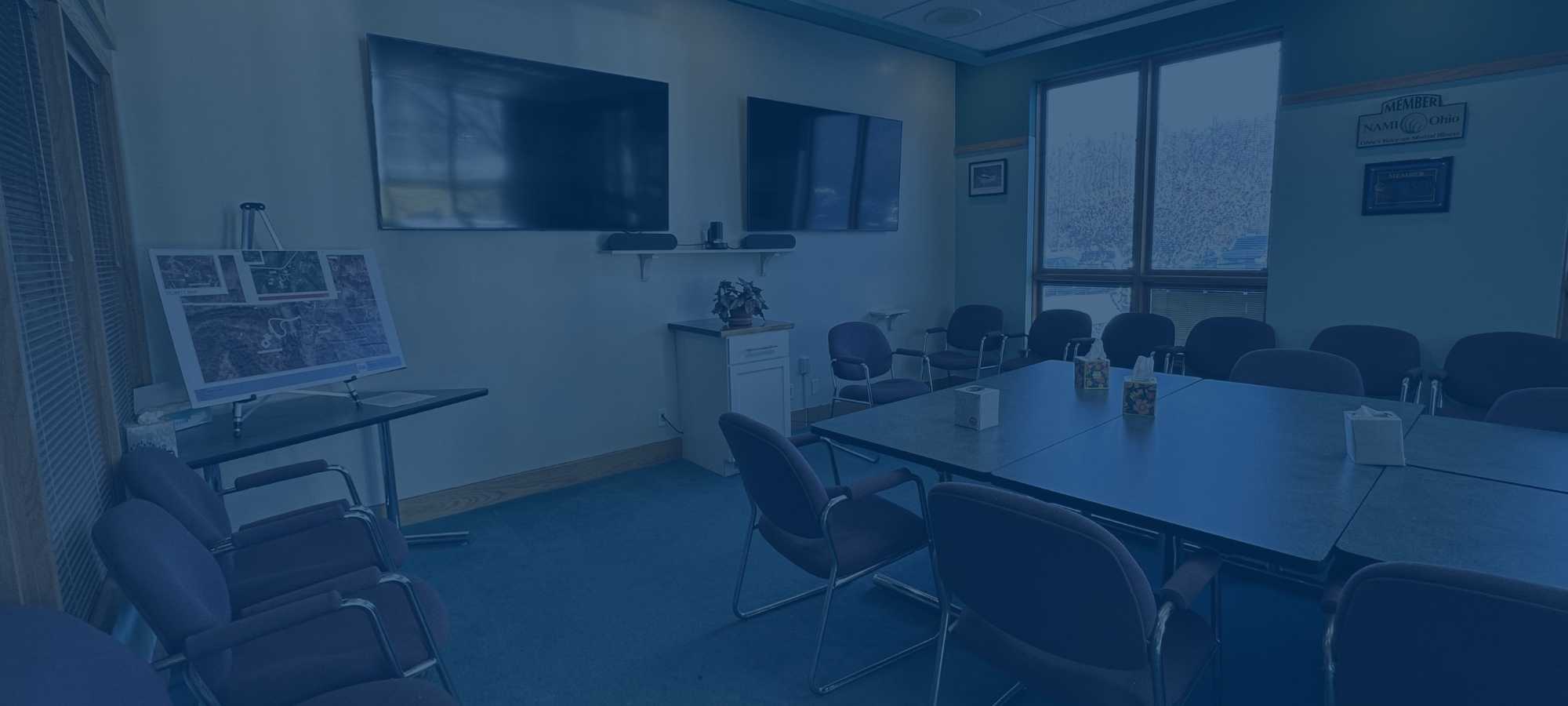 Photo of 317 board conference room with dark blue overlay